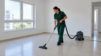 Cleaner vacuuming an empty apartment before handover
